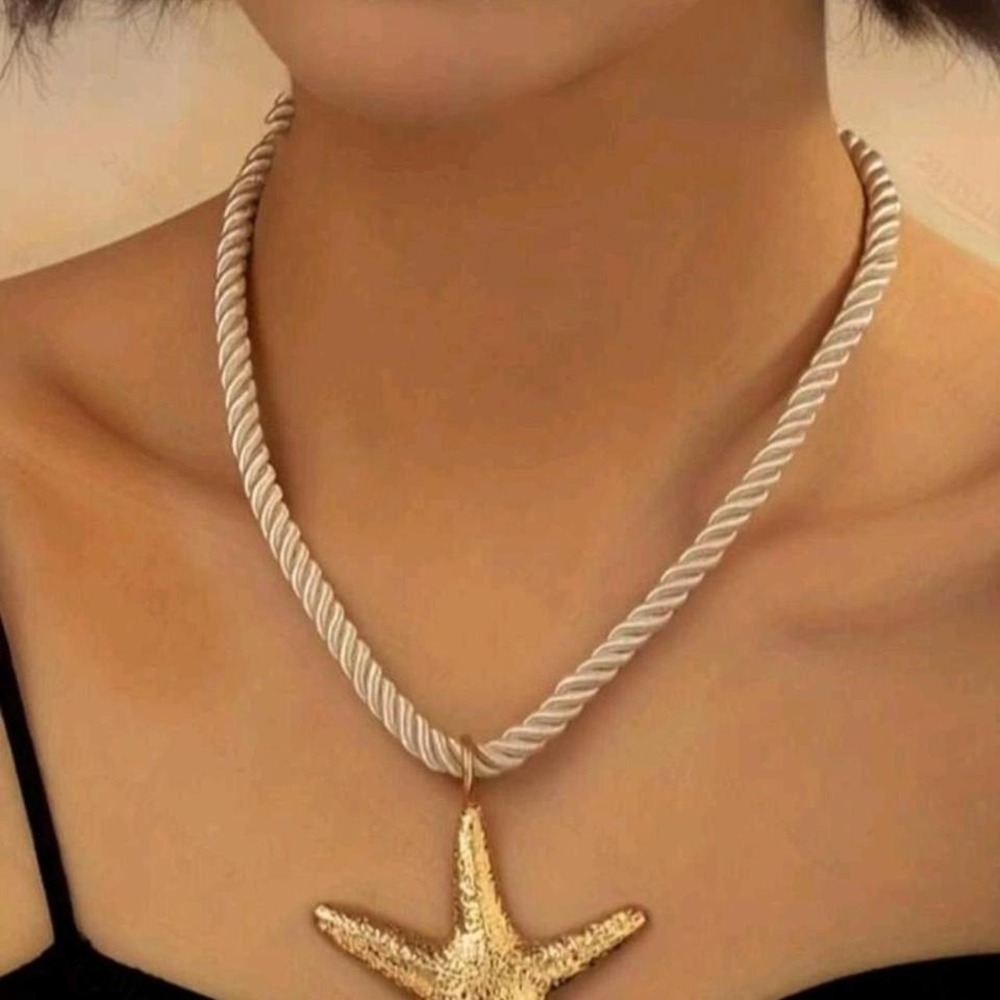 Gold plated starfish pendant‎ necklace on a cream rope chain
